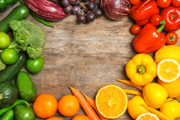 Rainbow composition with fresh vegetables and fruits on wooden background, flat lay