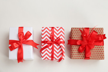 Beautifully decorated gift boxes on white background, top view