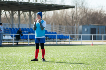 Boy soccer player on sports field