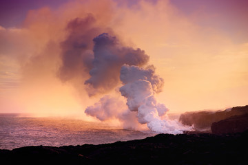 Lava pouring into the ocean creating a huge poisonous plume of smoke at Hawaii's Kilauea Volcano,...