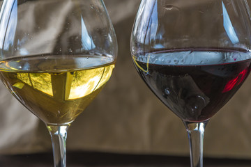 Two glasses of red and white wine close up