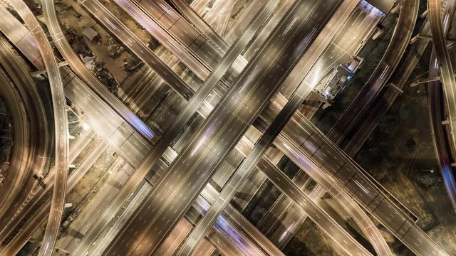 Hyperlapse timelapse of night city traffic street intersection circle roundabout in Bangkok, thailand. 4K aerial view by a drone.
