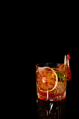 Blood Orange Margarita coctail with ice and mint on black