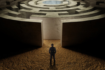 businessman standing in front of entrance of labyrinth,business strategy concept.