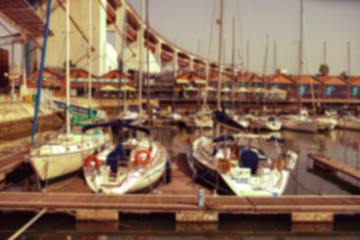 View of the dock with yachts and boats . Blurred image .
