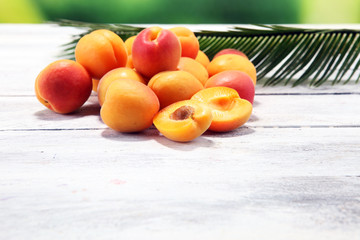 Bunch of fresh apricots on wooden table.