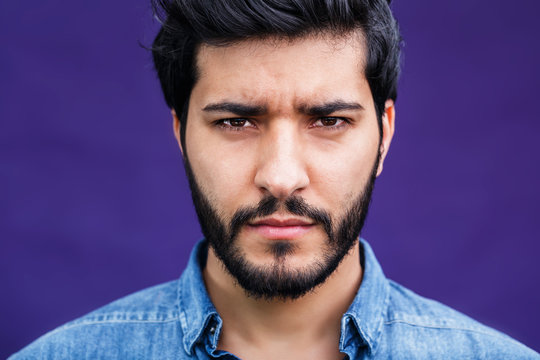 Portrait of eastern arabian man on purple background
