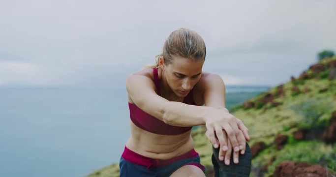 Athletic young woman stretching before run
