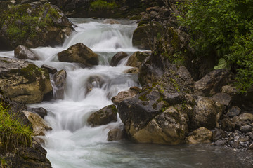 Fototapeta na wymiar Fast mountain river at summer