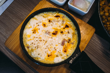 Bacon and cheese in baking dish.