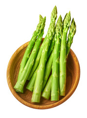 Fresh green shoots of asparagus in a wooden bow