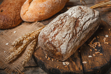 bread in rustic style retro background.Fresh traditional bread on wooden ground with flour in a sack.