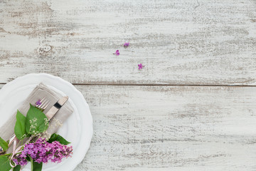 Rustic table setting with lilac flowers