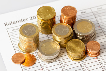 Euro coins in pile on appointment book, for background. Germany