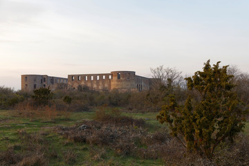 Fototapeta na wymiar Ruin of the Borgholm castle in evening light, built around year 1100 used for defence of the Baltic sea.