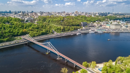 Aerial top view of pedestrian Park bridge, Dnieper river and Kyiv hills from above, city of Kiev, Ukraine
