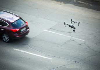 Quadcopter UAV`s drone for commercial aerial photography fly over motorway, at caught up with the...