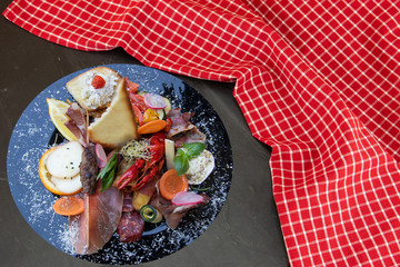 Mixed typical Italian antipasto with ham vegetables and cancer.