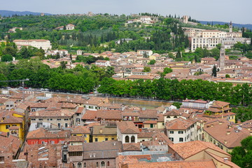 Fototapeta na wymiar View of buildings and roofs in the old city of Verona, Italy, seen from the top of the Torre dei Lamberti tower