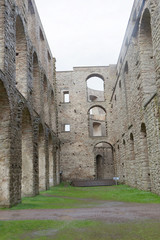 Naklejka premium High stone wall with many arches of the ruin of the Borgholm castle, built around year 1100 used for defence of the Baltic sea.