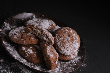 oatmeal cookies on a black table in castor sugar