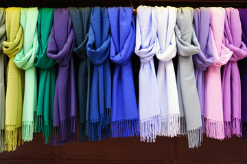Colorful hanging display of wool scarves 