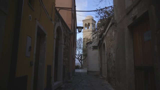 Tilt up, tower above alleyway in Taormina