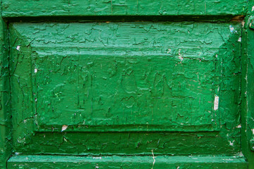 The decoration of wooden door texture with green paint is severely weathered and peeling