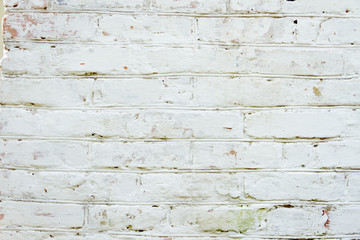Old grungy brick wall background texture white painted and weathered