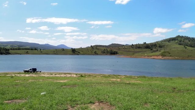 Australian lake, UHD pan view of Lake St Clair and surrounding nature landscapes, on a sunny summer day, in Sydney, Australia