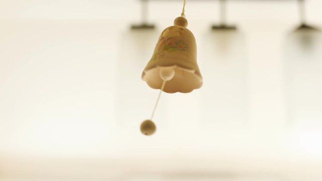 hand made ceramic bell hanging day light on background wedding decoration couple of pigeons birds in love idyllic ornament art design interior traditional custom clay souvenir beige color closeup