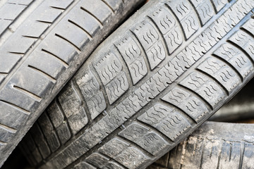 Various old car tires lying on each other.