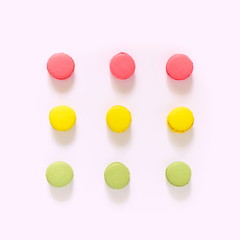 Creative layout made of colorful macaroons on the white background. Food concept. Flat lay, top view, copy space, square 