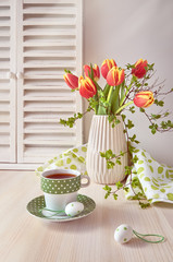Springtime greeting card design with bunch of red tulips, espresso in green cup with white dots and cookies