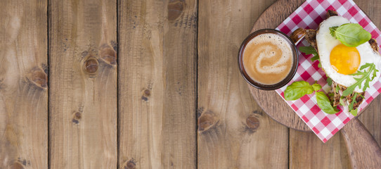 Sandwich of corn bread with egg and ham for breakfast. A healthy and delicious breakfast and coffee. Wooden background. Fitness food, toast. Top view, banner