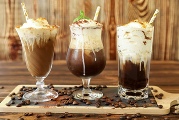 Three glasses of different cold coffee drinks.