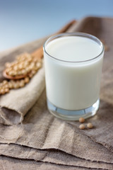 Soy milk with soy beans around it.