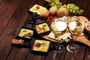 Delicious traditional Swiss melted raclette cheese on diced boiled or baked potato.