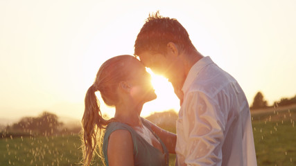 LENS FLARE: Lovely Caucasian couple dances in the picturesque summer countryside