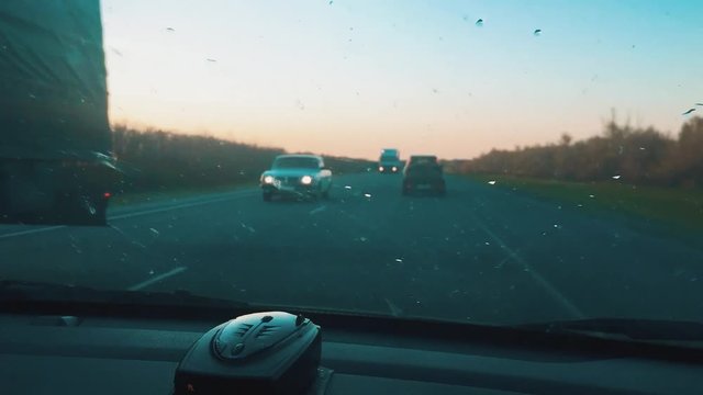 man rides on an auto beautiful sunlight silhouette of a sunset slow motion video. man driving car travel concept lifestyle