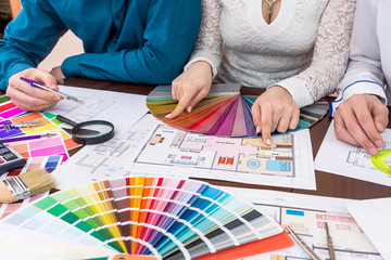 Teamwork of designers choosing colors for rooms in house