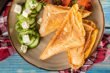Sandwiches with cheese, tomatoes and cucumber.