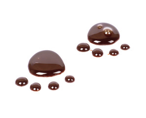 Chocolate puddles in the form of stylized tracks on white background