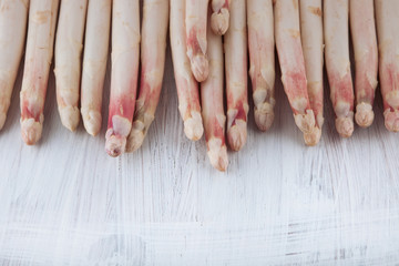 bunch of white asparagus decorated on a white wood table, can be used as background