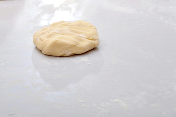 The dough is on the table, the flour is ready to be baked for pies and rolls