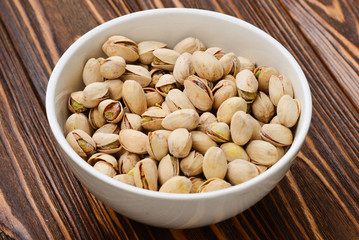 Pistachios on a wooden table. Top view. Space for text or design.