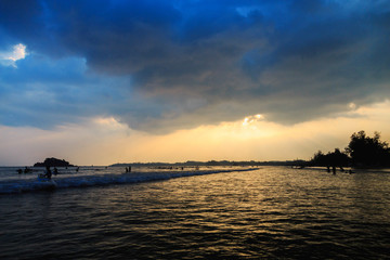 sunset over the ocean on a cloudy day