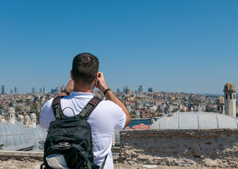 Fototapeta na wymiar Male tourist taking a photo of Istanbul