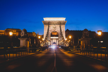 Night view of a famous Budapest Szechenyi Chain Bridge, a suspension bridge that spans the River Danube between Buda and Pest, the western and eastern sides of Budapest
