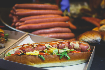 Fried baked sausages, hot dog on street food outdoor market stall in Budapest, Hungary, european street food.